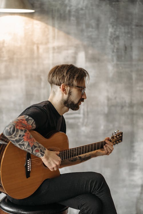 A Man Playing Acoustic Guitar
