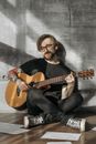 Man in Black Crew Neck T-shirt Playing Brown Acoustic Guitar