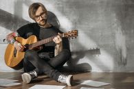 Man in Black Long Sleeve Shirt Playing Brown Acoustic Guitar