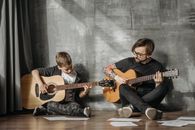Man and Child Playing Guitars