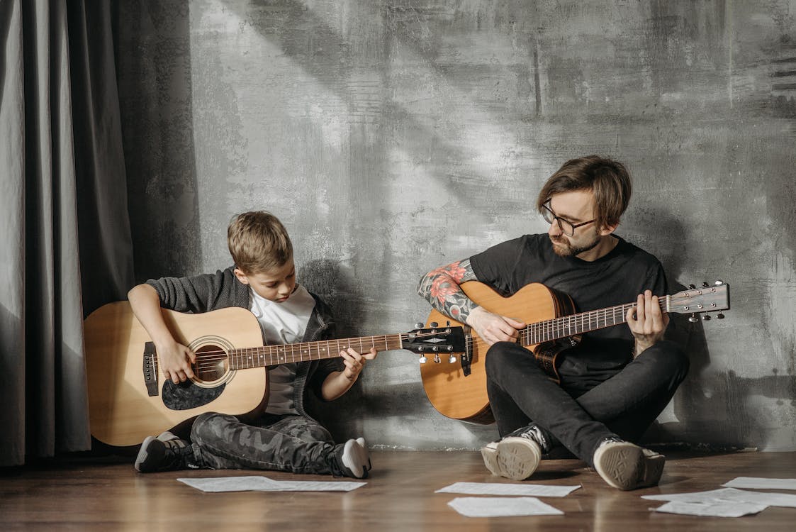 Free Man and Child Playing Guitars Stock Photo