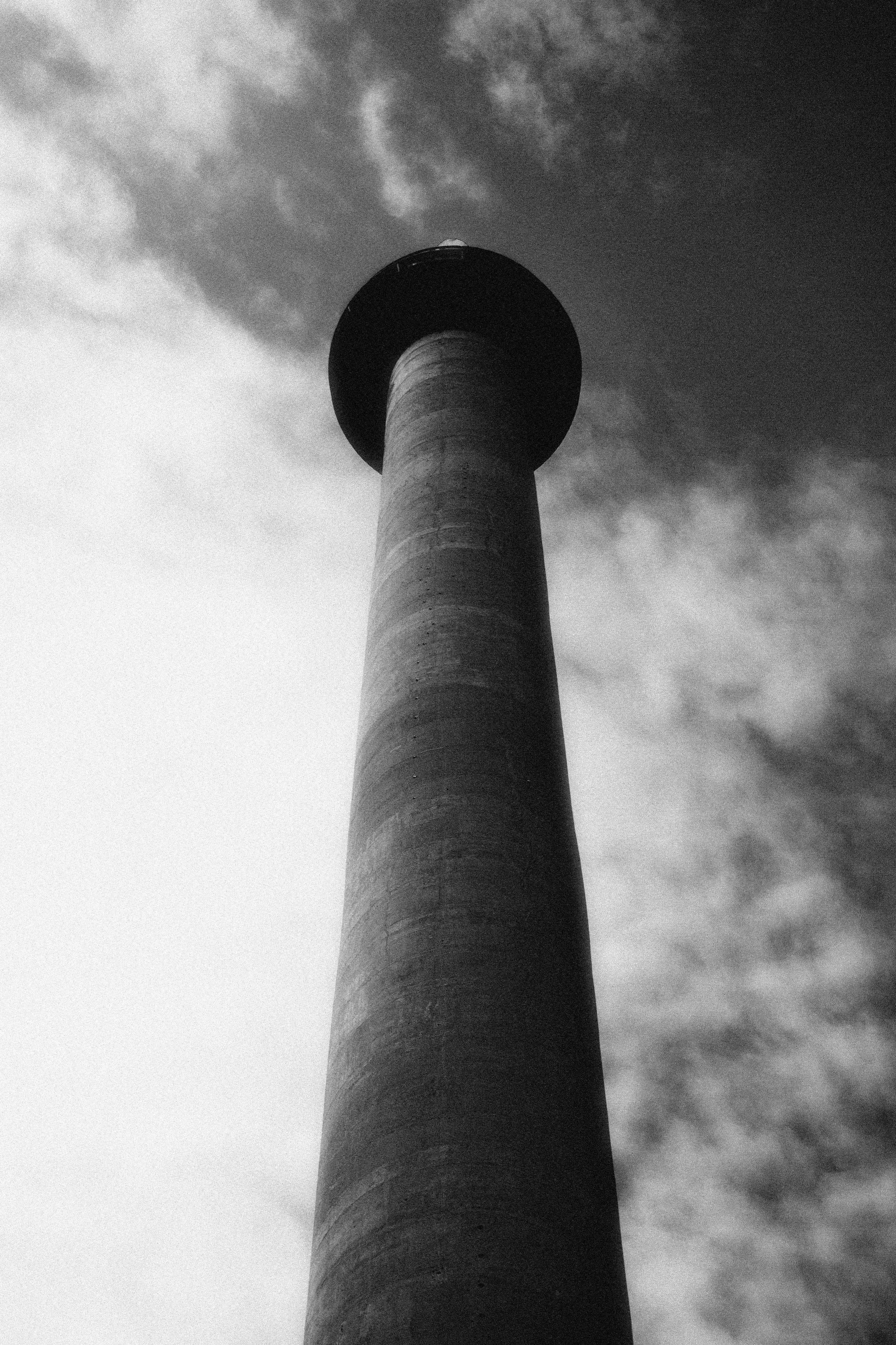 grayscale photo of concrete tower