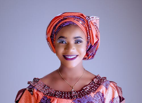 Smiling Woman in Colorful Makeup Wearing a Turban 