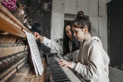 Free A Girl Having a Private Piano Lesson Stock Photo