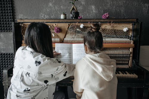 Free Back View of People Having a Piano Lessons  Stock Photo