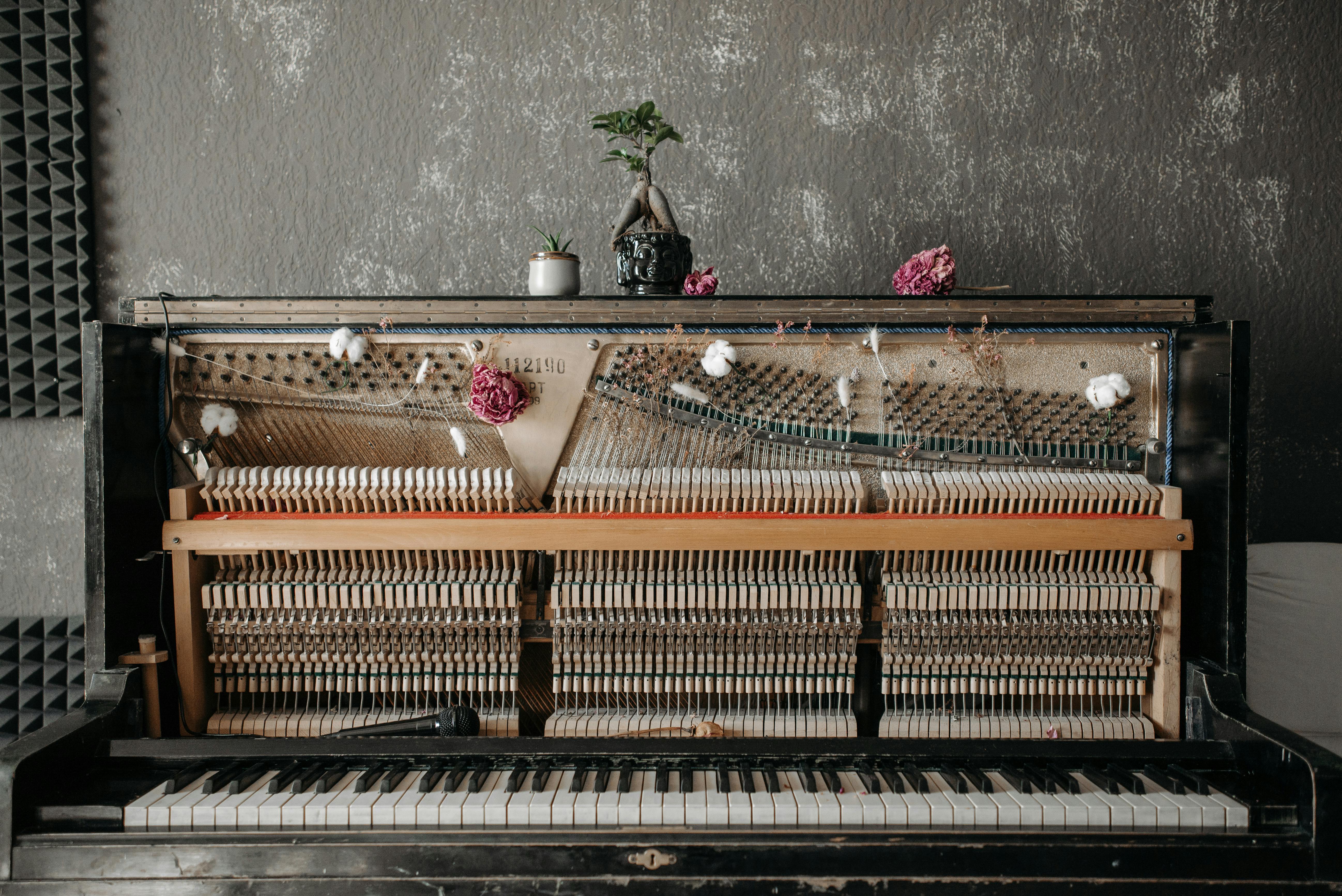 pink flowers on brown wooden piano