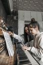Woman in Black Leather Jacket Playing Piano