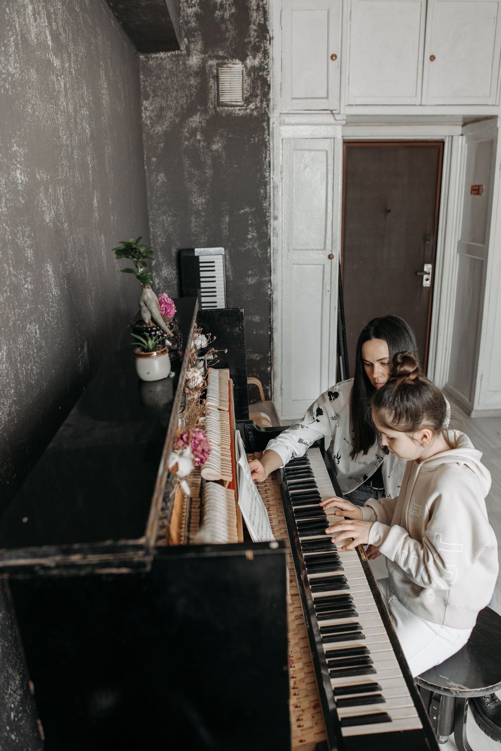 Girl playing piano during a lesson