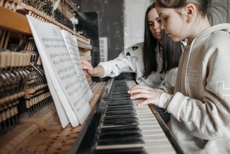 Girl In Beige Hoodie Playing Piano