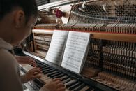 Person Playing Piano With Musical Notes