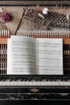 A close-up view of an antique piano with open sheet music and rustic decorations.