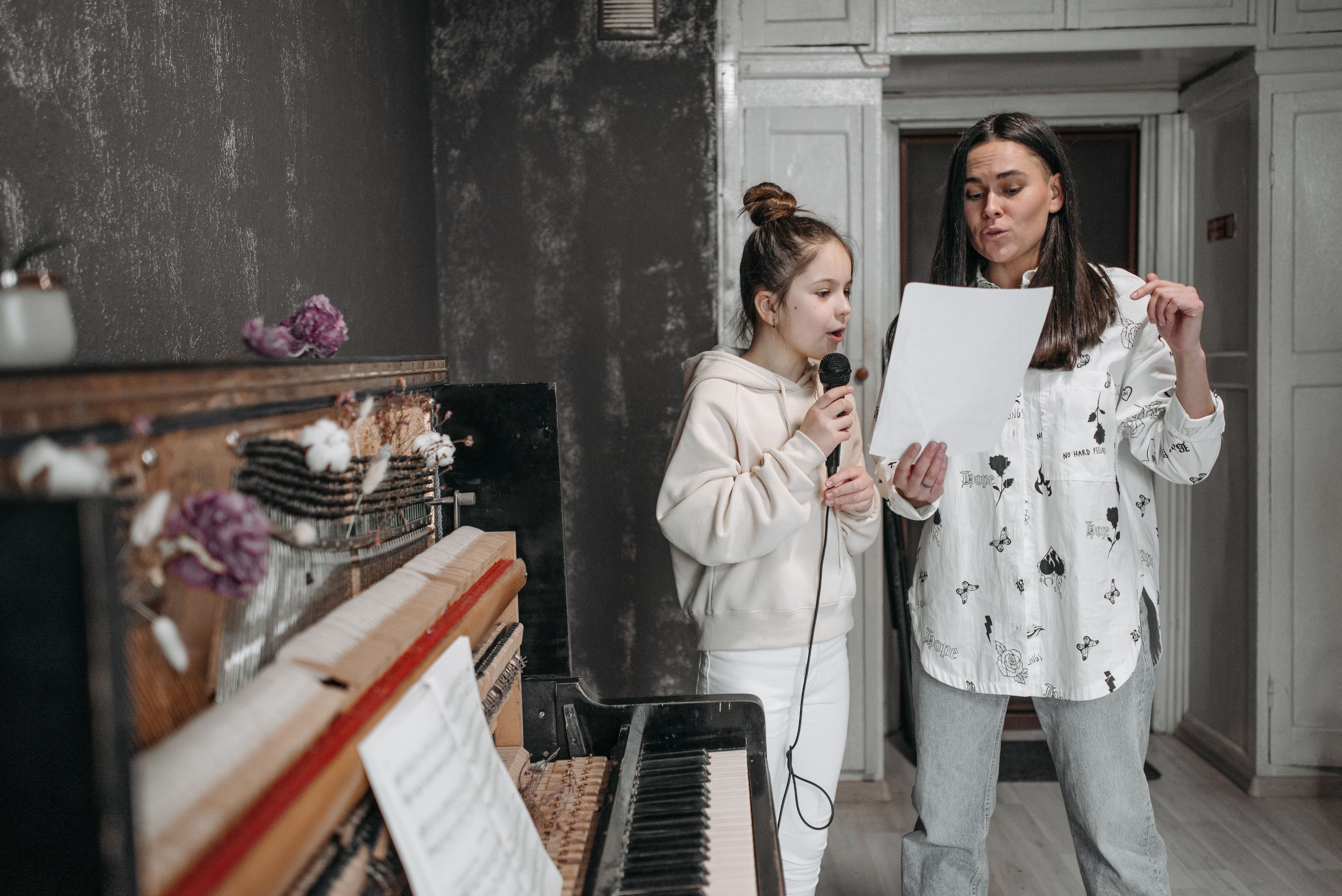 A voice lesson at the piano, student at the microphone