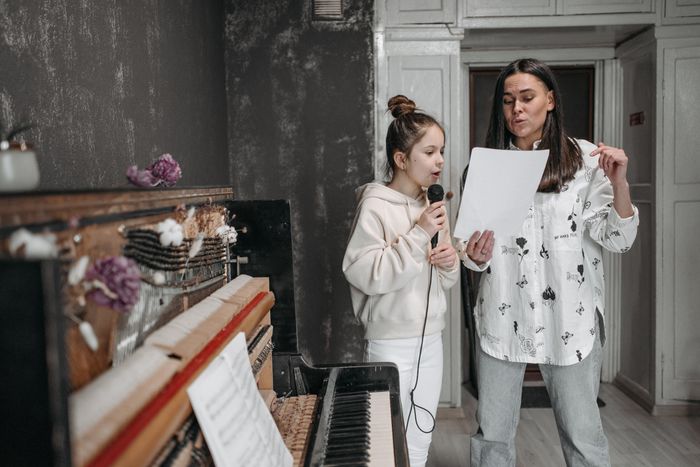 Angela teaching a student to sing
