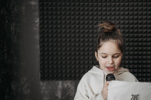 A Girl in Hoodie Jacket Holding a Microphone