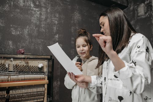 Free A Teacher Teaching a Student How to Sing Stock Photo