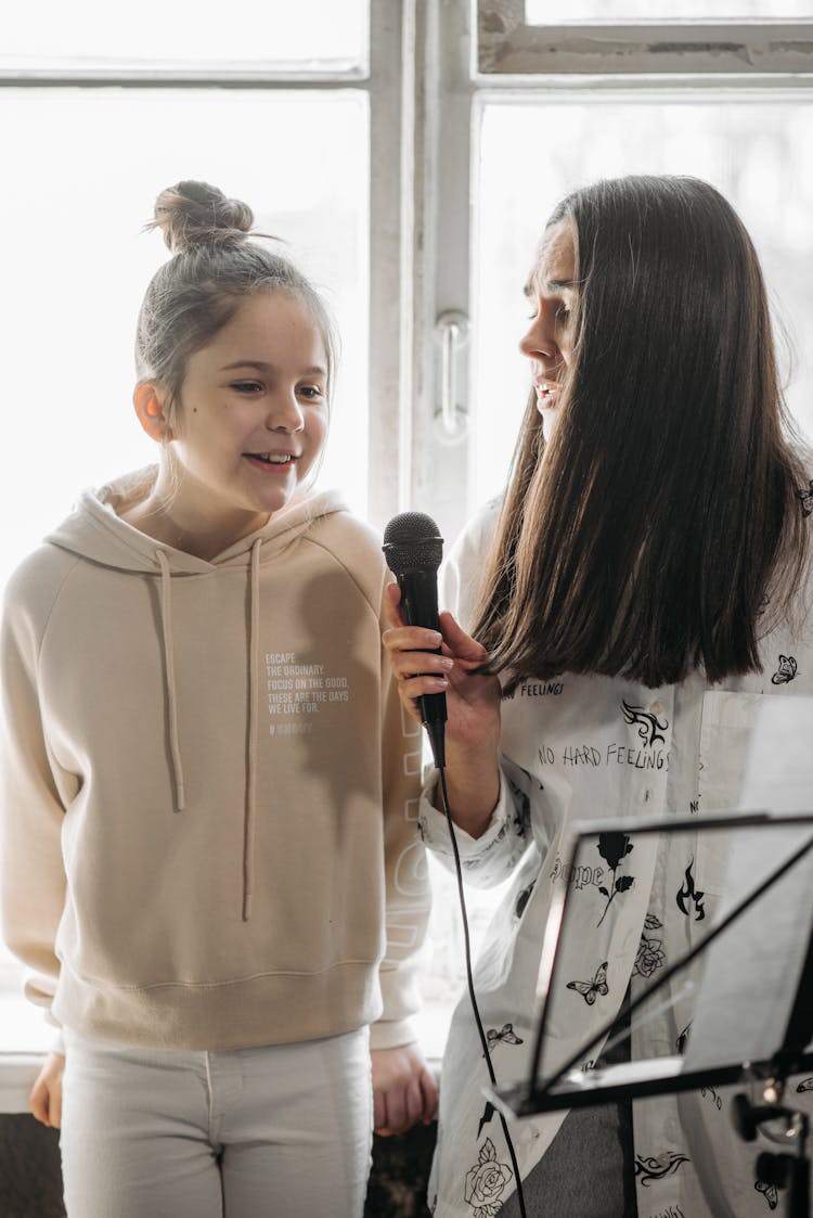 A Woman And Girl Singing Together 