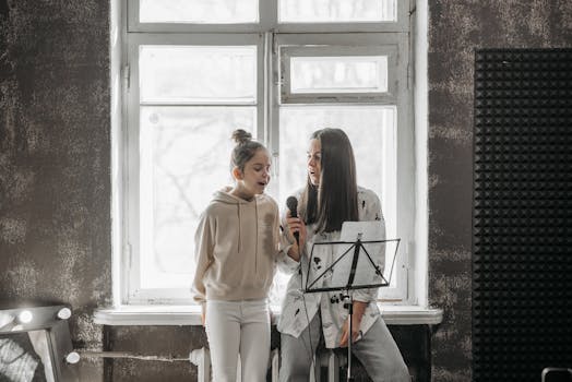 A Woman Teaching a Girl How to Sing