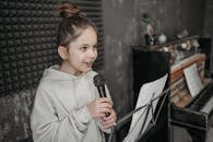 Woman in Beige Coat Holding Microphone