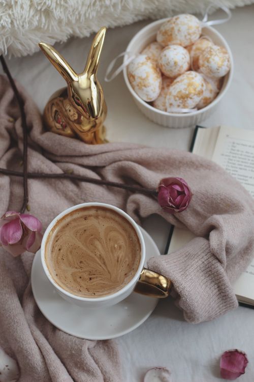 Free Aesthetic flat lay featuring coffee, Easter eggs, and pink flowers in a cozy setting. Stock Photo