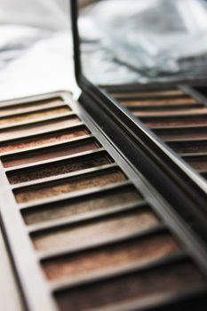 Close-up of a neutral tones makeup palette reflecting in a mirror with blurred background.. pexels, close, neutral