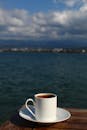 Mug of Coffee in Sunlight and Seascape