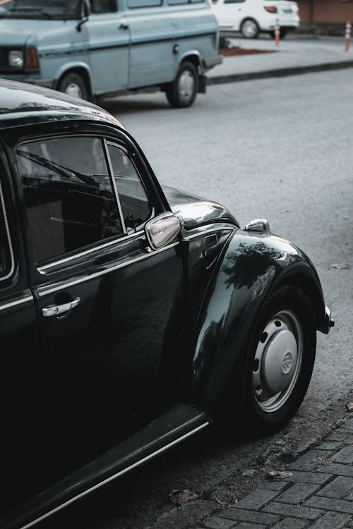 Vintage black automobile parked on roadside