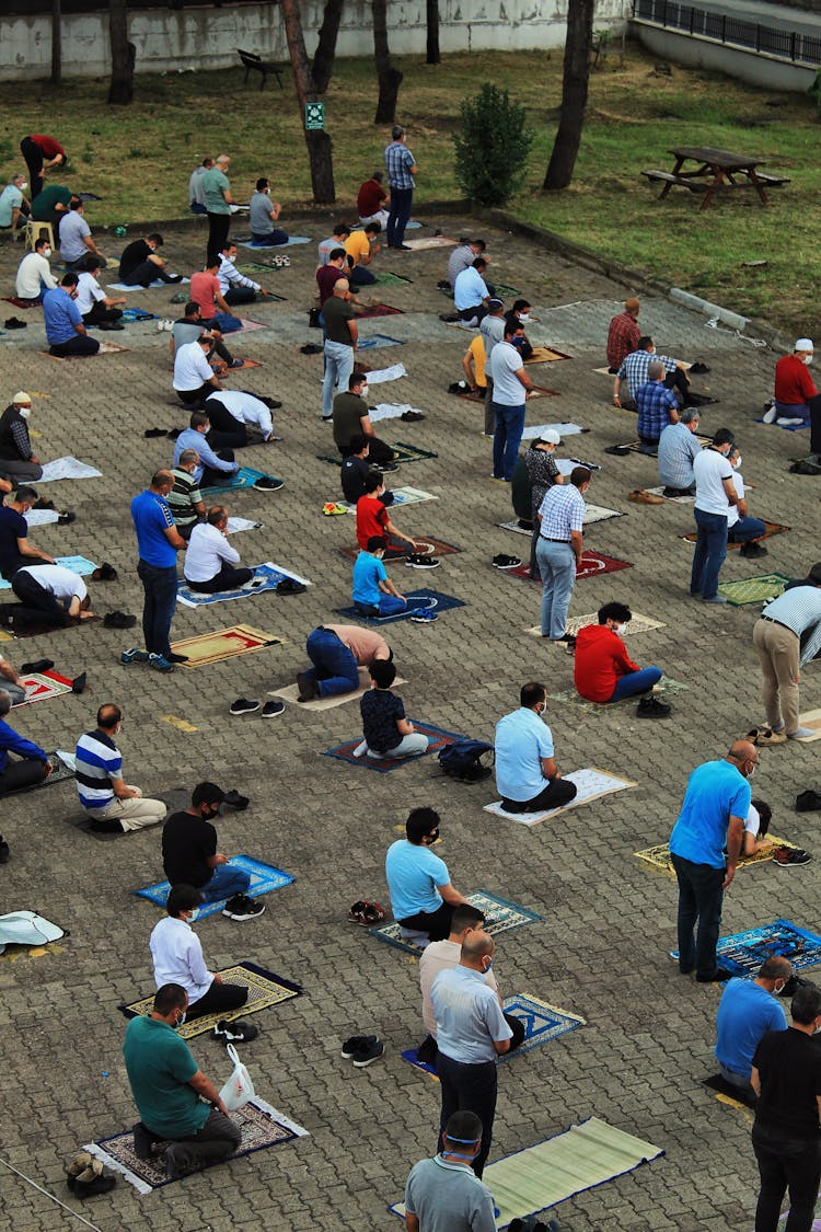 Group Of People Praying In Park