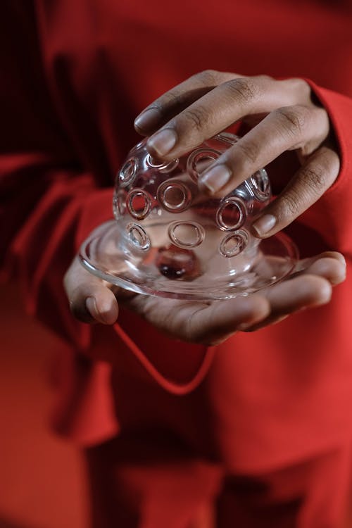A Person Holding a Clear Glass Jar