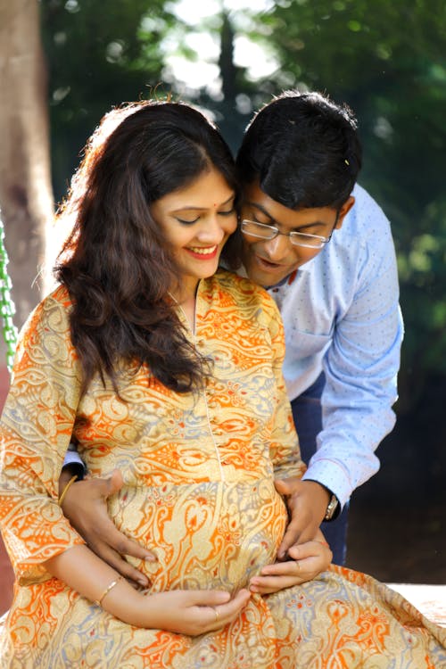 A Man Holding the Baby Belly of His Partner