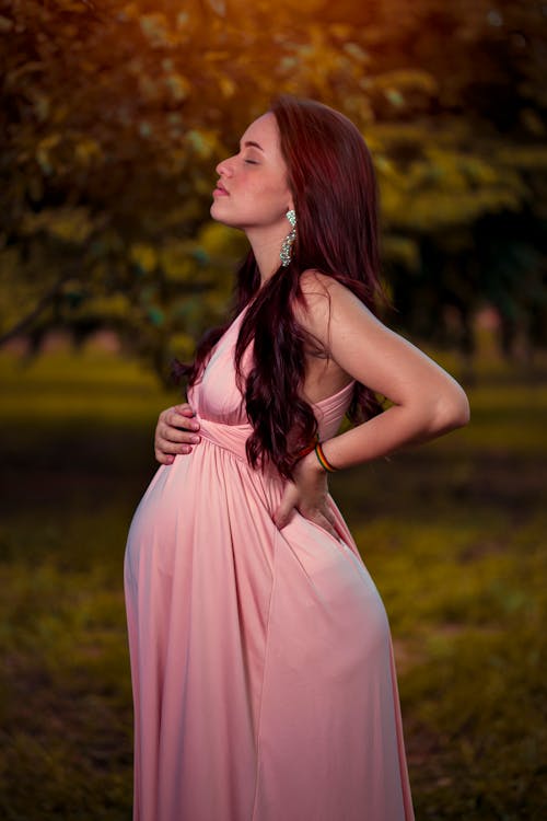 A Pregnant Woman in a Pink Dress