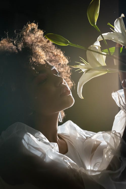 A Woman Holding a Bunch of Lilies