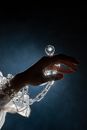 A Hand Wearing a Plastic Diamond Ring with Chains