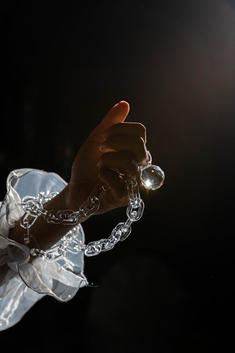 Person Holding Transparent Necklace