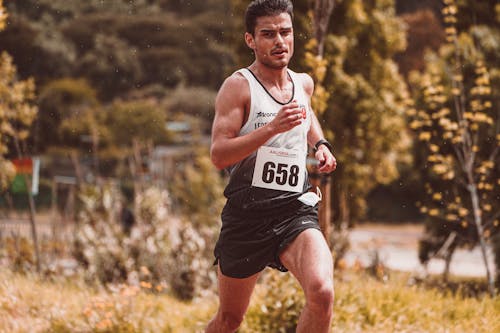 Selective Focus Shot of a Man Running a Marathon