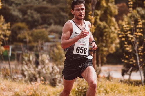 Free Athlete participating in an outdoor marathon with race number 658 during daytime. Stock Photo