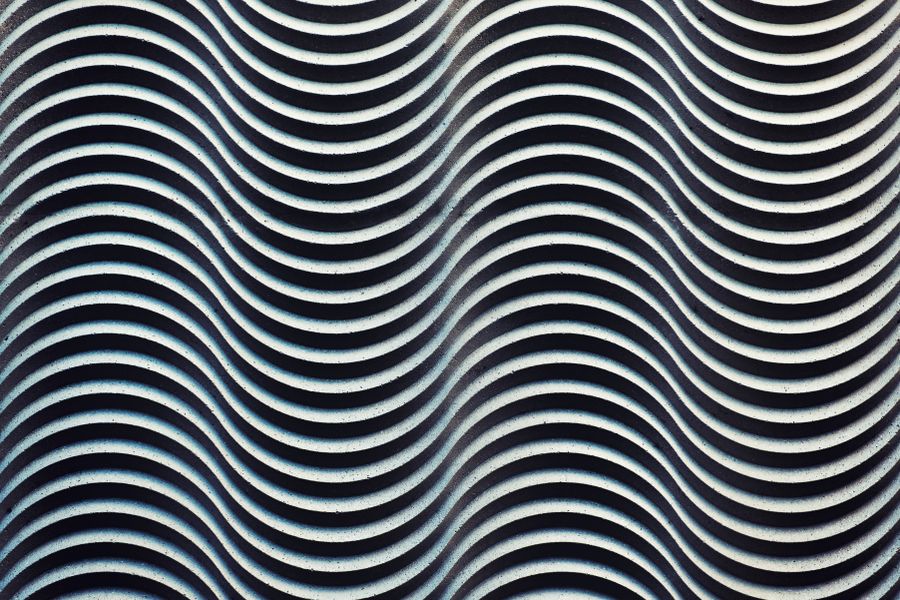 Monochrome abstract wave pattern creating a hypnotic design with repetition and depth.