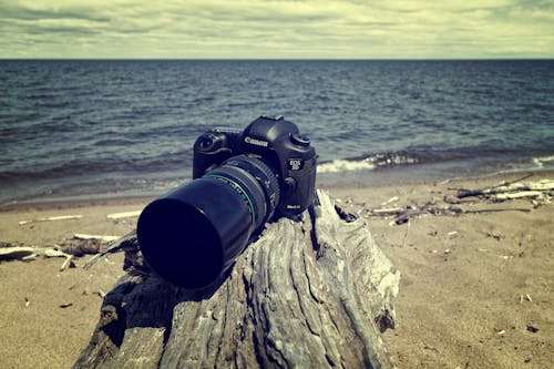 Black Canon Dslr Camera Near Sea Shore