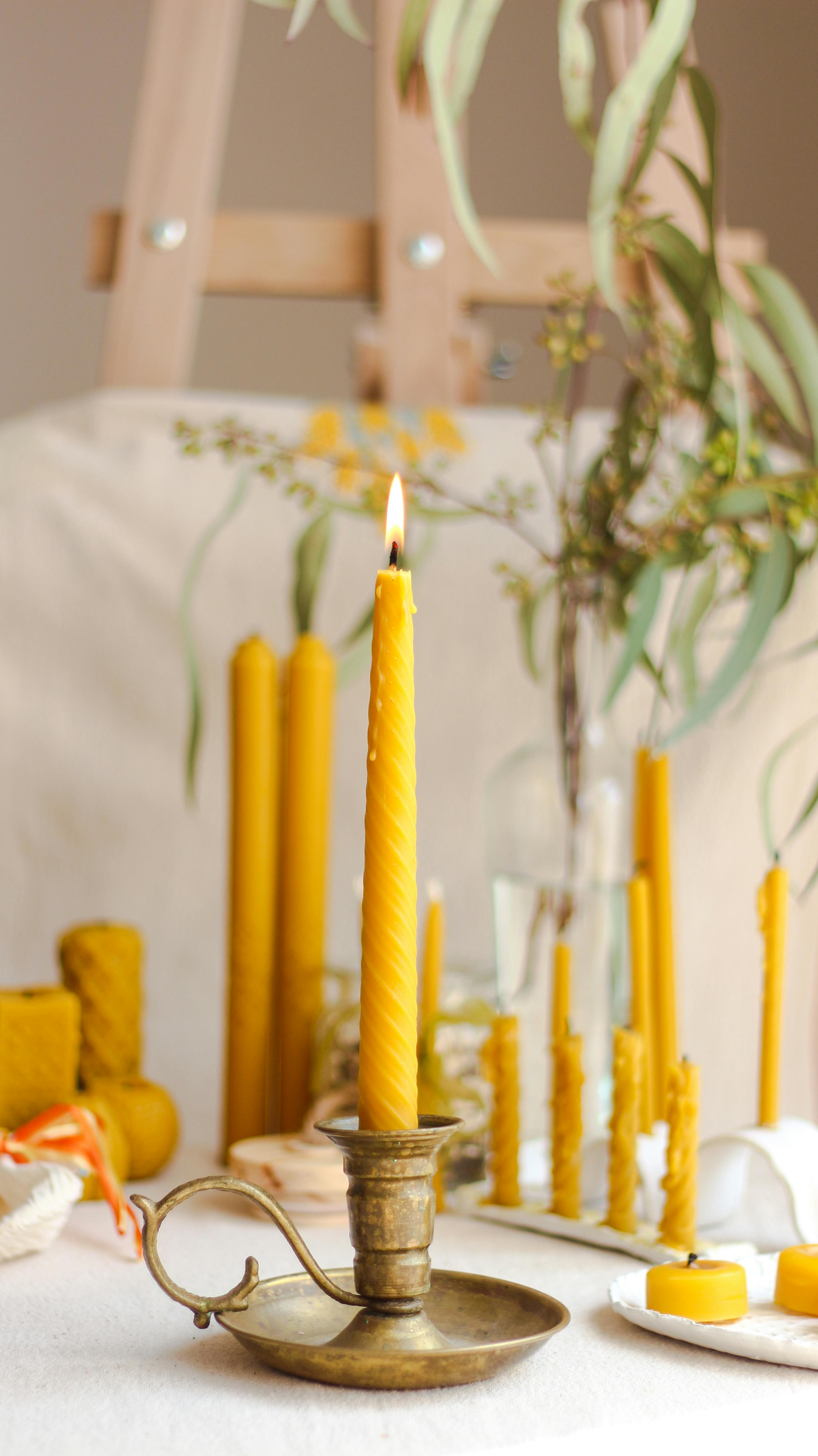 vintage candlestick with burning candle on table at home