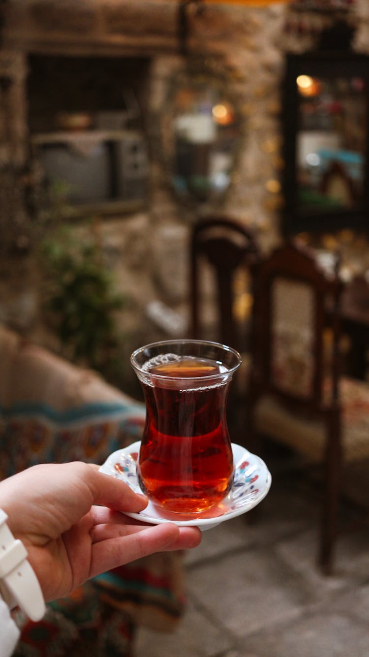 Crop Person With Turkish Glass Of Tea At Home