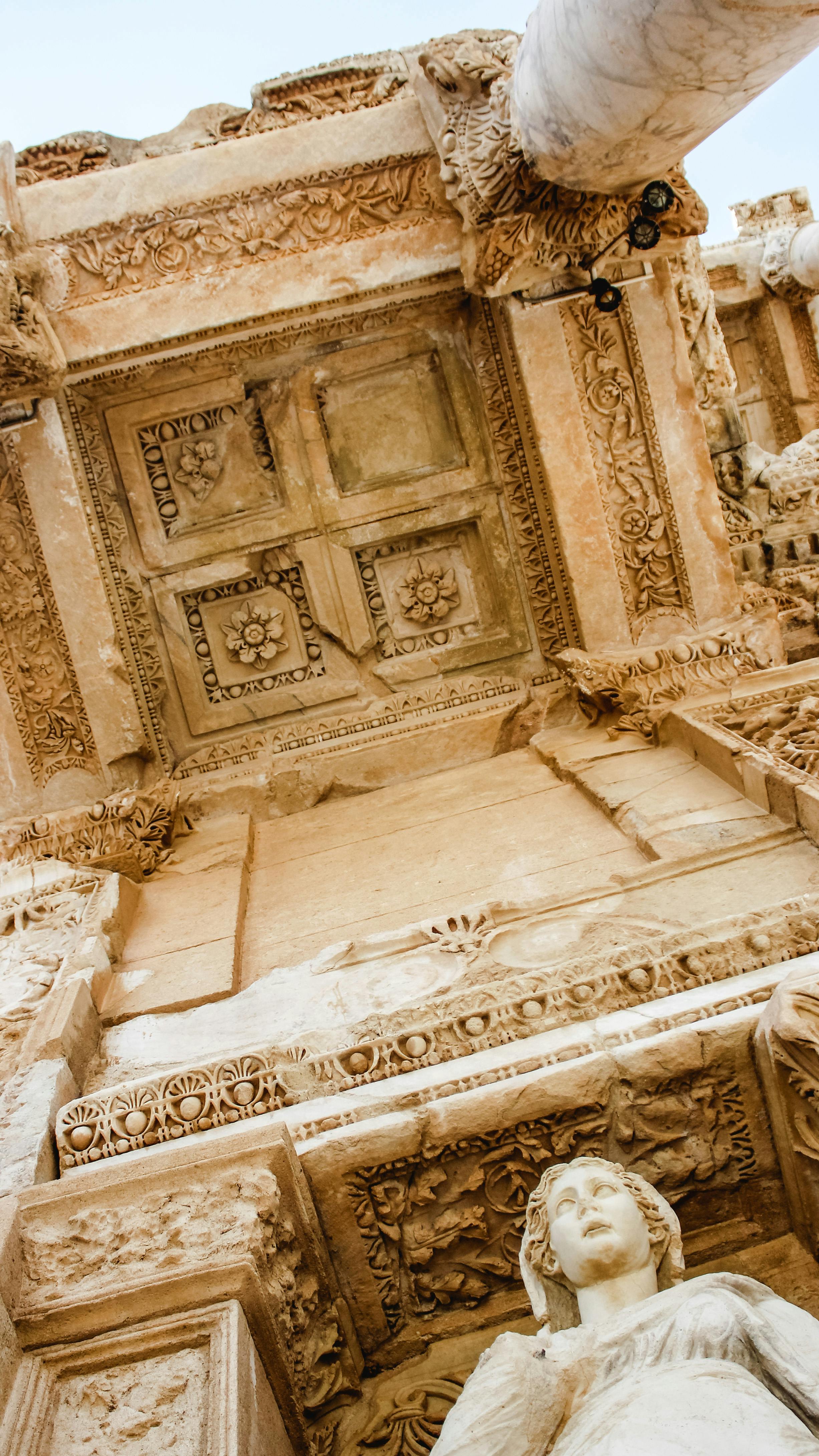 library of celsus with sculpture and damaged wall