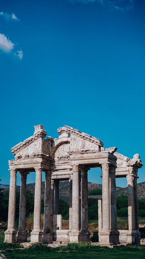 Free Temple of Aphrodite with colonnade and decor against mountains under cloudy sky in Knidos Turkey Stock Photo