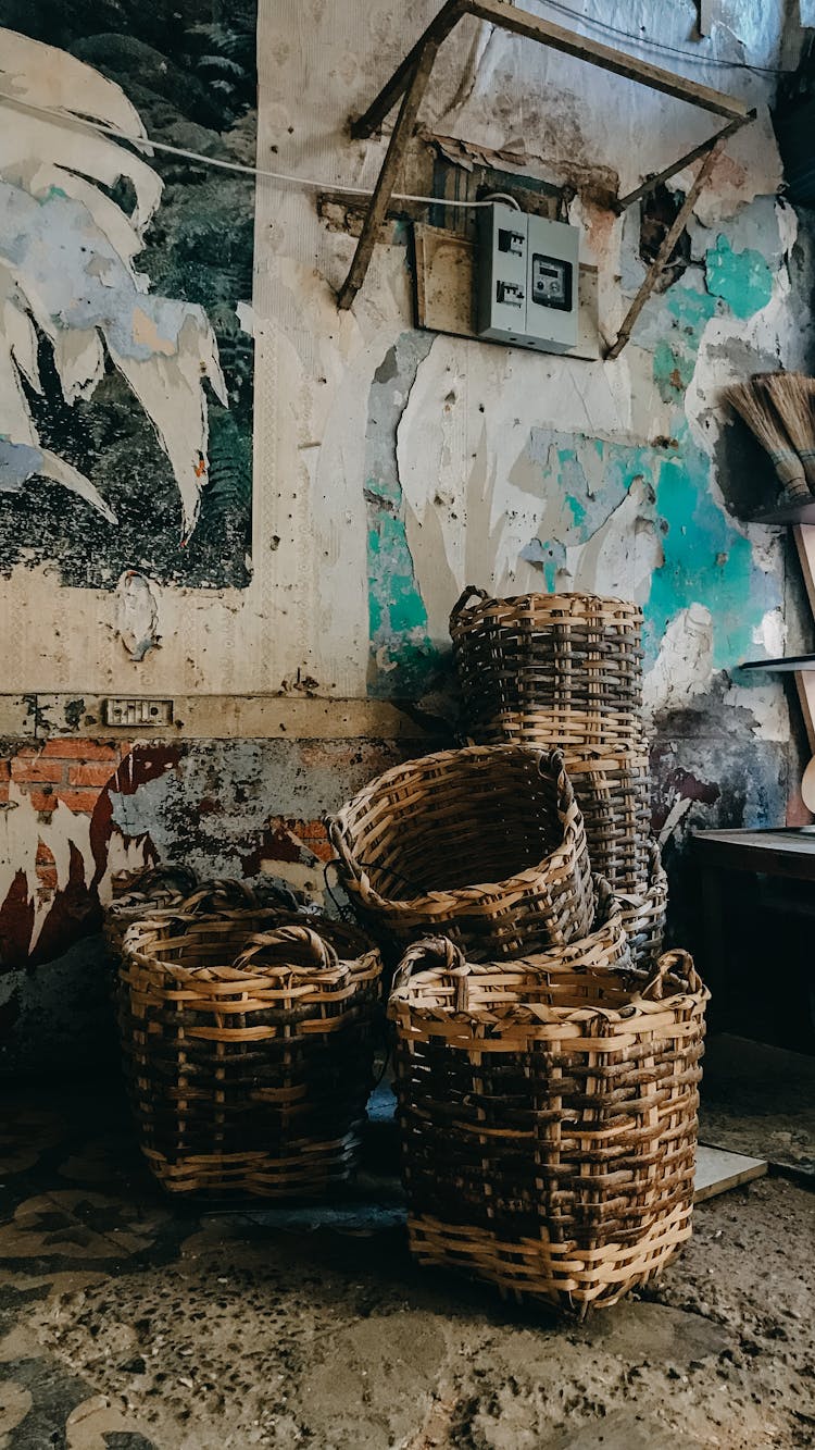 Wicker Baskets Against Rough Wall With Painting