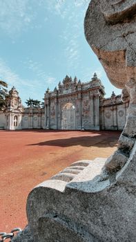 Stone walls and ornamental gates with carved relief and stucco elements at entrance of Dolmabahce Palace in Istanbul