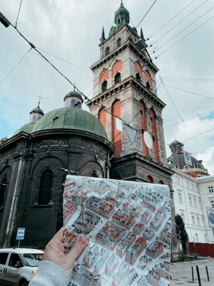 Unrecognizable Person With Map Near Historical Buildings