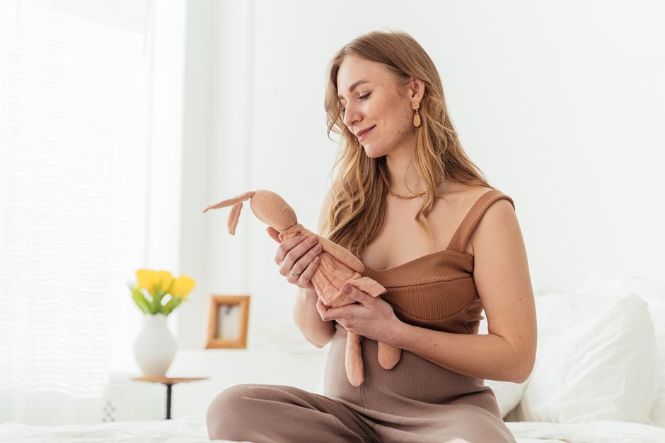 A smiling pregnant woman feeling comfortable and relieved from gas pain. - pregnancy gas pain A smiling pregnant woman feeling comfortable and relieved from gas pain. - pregnancy gas pain