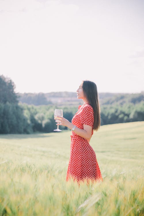 Side View of a Woman Holding a Wine Glass 