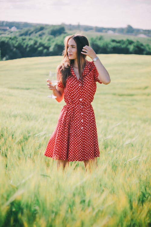 Free A Woman Standing in the Middle of the Farmland Stock Photo