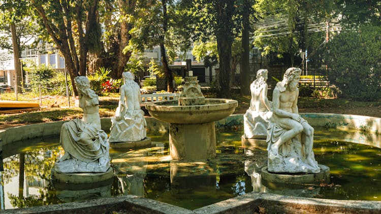 White Statues On Water Fountain