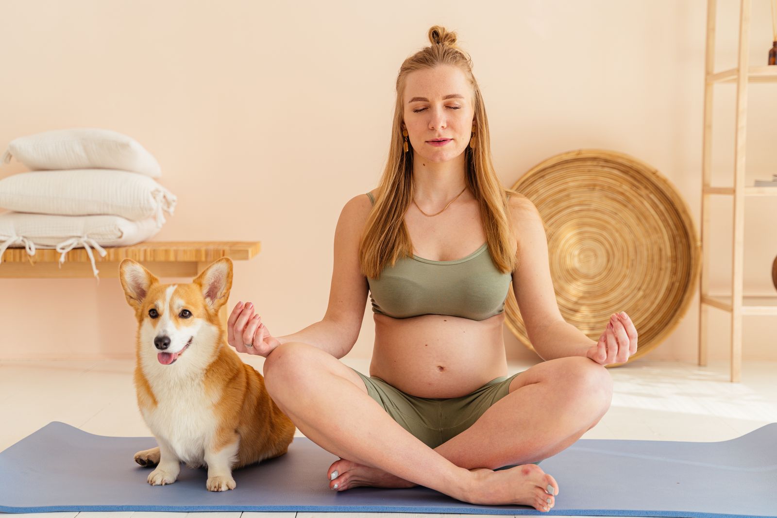 Pregnant woman mid-pregnancy stretching carefully during a workout
