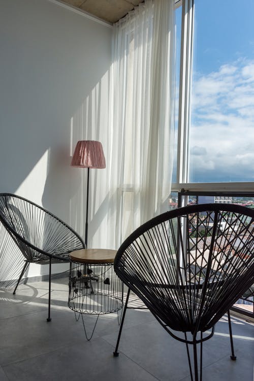 Black Metal Chairs near Glass Window